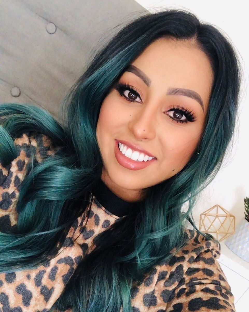 Smiling Woman with Teal Hair – Customer showcasing Tealistic hair color results after using Punky Colour color-depositing shampoo.