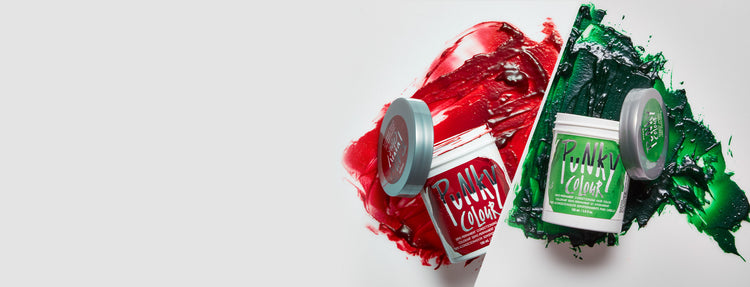 Two containers of red and green hair color on a white background