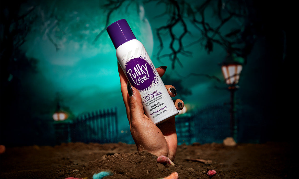 Hand coming up from the ground grabbing a punky colour spray bottle