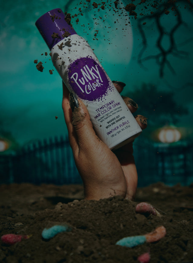 Hand holding a bottle of TEMPORARY HAIR COLOR SPRAY - PANTHER PURPLE, styled for Halloween 