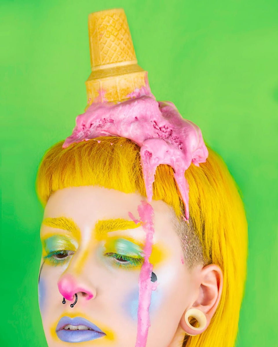 Yellow Hair with Ice Cream – Model with bright yellow hair styled with melting pink ice cream cone, featuring bold, artistic makeup.