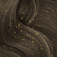 Gold glitter in dark brown hair close-up – A close-up of shimmering gold glitter applied to dark brown hair, adding a sparkling effect.