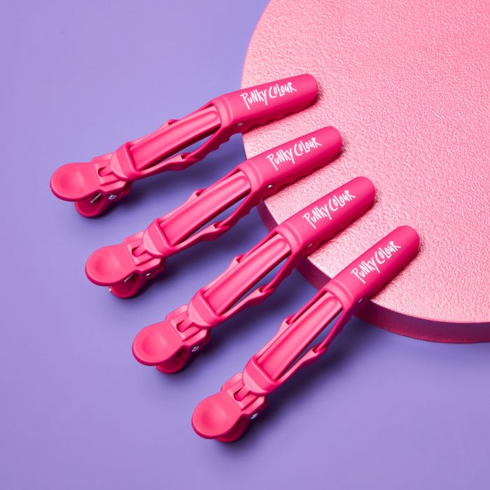 Four pink Punky Colour Hair Clips displayed on a purple and pink background.