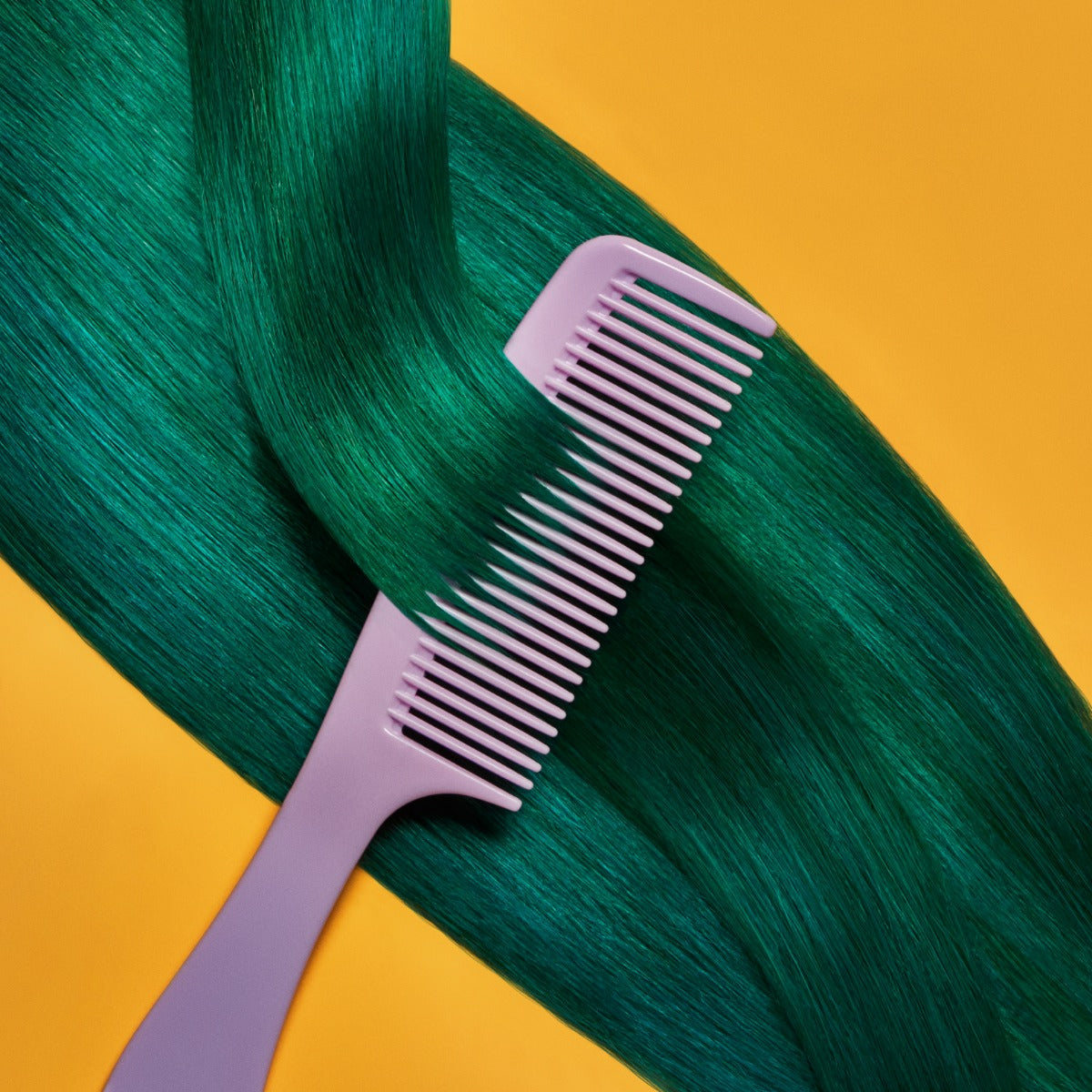 A section of straight, bright green  hair on a yellow background being combed, showcasing the Punky Colour Sugar Cloud Semi Permanent Foam Color
