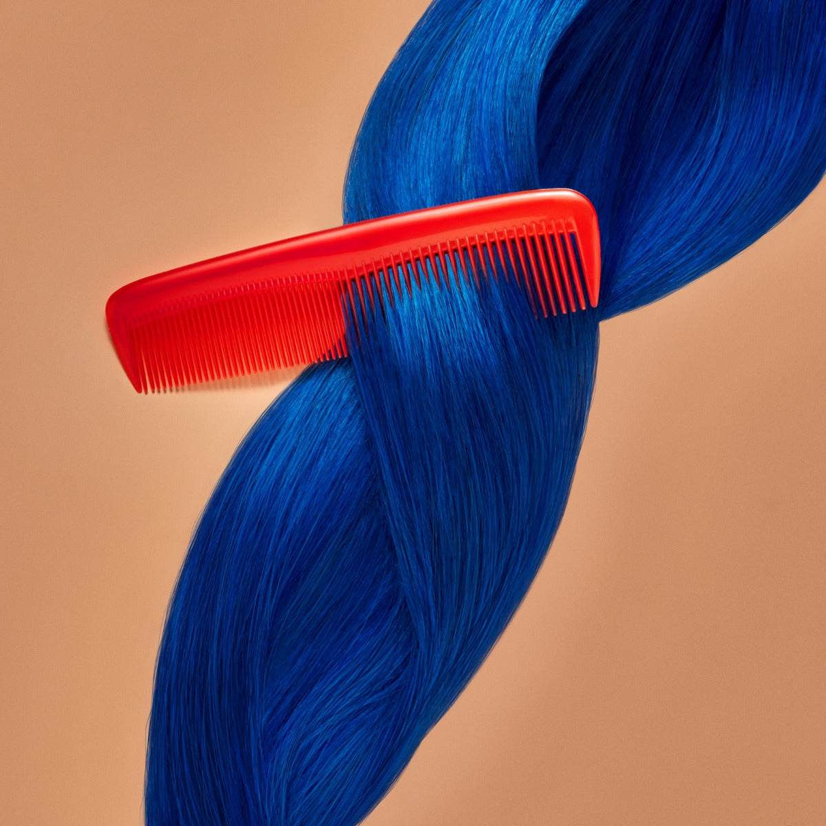 A section of straight, bright blue hair on a orange-brown background being combed,  showcasing the Punky Colour Sugar Cloud Jawbreaker Semi Permanent Foam Color