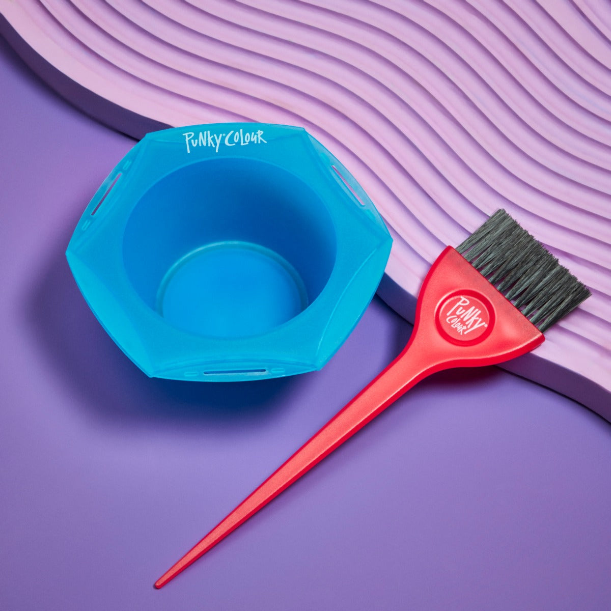 Blue Tint Bowl and Brush on Purple Background – Punky Colour tint bowl and red brush set on a stylish purple textured surface.