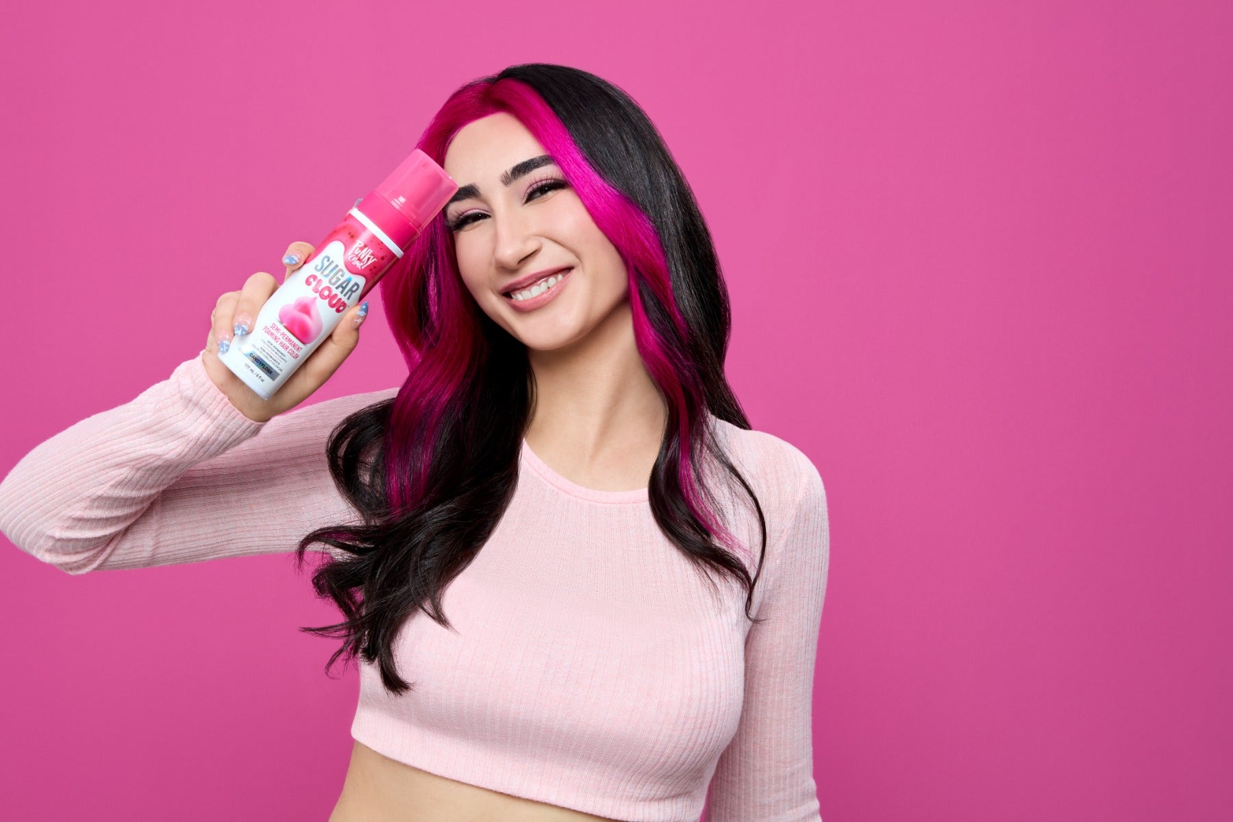 Model with colored hair holding up a spray can of  Punky Colour Sugar Cloud Semi Permanent Foam Color