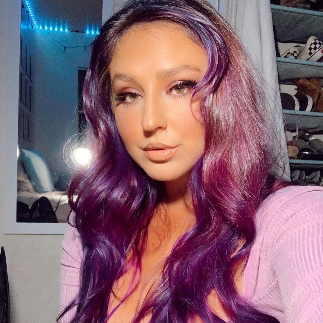 Punky Colour Purple ombre hair – A woman with wavy purple-toned hair, styled effortlessly for a trendy and radiant look.